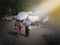 Back view of couple under the umbrella in the evening against the double-decker in thailand.