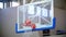 Back view of disabled player throwing ball in a basketball hoop, the ball hits the ring and scores.