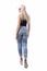 Back view of elegant stylish modern blond hair girl in jeans walking away looking at side