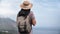 Back view elegant travel woman in straw hat and backpack admiring amazing sea scenery mountain peak