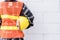 Back view of engineer, architect, supervisor worker wear reflective clothing for the safety of the work operation hold safety