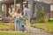 Back view of family hugging and admiring their home