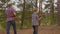 Back view of father and son carrying firewood in forest