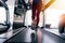 Back view of feet with sneakers of female runner / jogger running on treadmill indoors in action