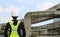 Back view of female construction worker against expressway background