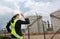 Back view of Female construction worker against gas separation plant