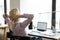 Back view of female employee relax in chair at desk