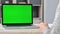 Back view female hands writing paper document use pen on desk laptop with green screen copy space