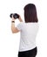 Back view of female photographer or videographer shooting video or taking photos on her dslr camera isolated on white