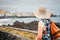 Back view of female tourist with rucksack admires view