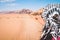 Back view female tourist stand watch point finger to wadi rum desert landscape in jordan desert-famous nature reserve in middle