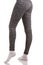 back view of fit woman legs in white socks standing in one leg and another bended in knee in grey patterned thermal pants