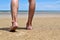 Back view foot, Young man foot on a natural beach with the sea in front.