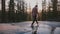 Back view of free young man stepping into small water stream enjoying amazing sunset hike at Yosemite park slow motion.