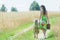 Back view full length portrait of walking mother and her little daughter on rural country road