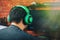 Back view of gamer in headphones playing video game