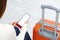 Back view of girl holding smartphone with white blank screen mockup. Traveler with phone at the airport with passport and suitcase