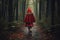 Back View of a Girl Wearing a Red Cloak Walking on a Gloomy Forest Path - Little Red Riding Hood. AI