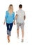 Back view of going couple. walking friendly girl and guy holding hands