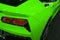 The back view of a green luxury sport car. Exhaust system. Modern Sport Car exterior details. Car detailing