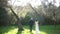 Back view of the groom and the bride walking hand in hand through the olive grove