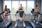 Back view of group of young people running on treadmills in sport gym . three fitness woman runner on running machine in morning