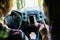 Back view of hands of young couple driving using navigation on mobile phone