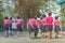 Back view of happiness primary girl students in pink shirt and blue skirt walk to classrooms