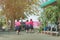 Back view of happiness primary girl students in pink shirt and blue skirt walk to classrooms