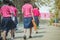 Back view of happiness primary girl students in pink shirt and blue skirt walk to classrooms