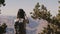 Back view happy young tourist woman taking smartphone photo of epic Grand Canyon mountain scenery view in Arizona USA.