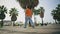 Back view hipster walking city square summer day. Guy going near tropical palms