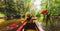 Back view Kayaking couple in river. POV of woman and man kayaking in beautiful landscape. Aquatic sports during fall autumn