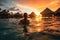 Back view of a lady swim in sea water at sunset. Summer tropical vacation concept.