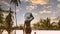 Back view  lifestyle with young woman in red bikini looking of sunset view at poolside