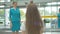 Back view of little girl waving to mother in stewardess uniform. Blurred child saying goodbye to parent leaving for