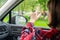 Back view of lonely girl touching by hand rainy window with drop of car.