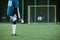 Back view of low section of footballer kicking soccer ball