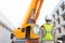 Back view of Male construction worker against crane background