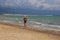 Back view of male walking in beach of Manfredonia