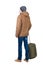 Back view of man in a brown jacket with suitcase .