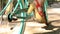 Back view of man pedalling a bike riding with woman on a seat or cargo rack. Low angle of young couple feet riding on