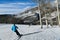 Back view of a man skiing down the slope