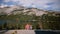 Back view man walks up to sit by a woman and kiss near amazing mountain lake scenery view at Yosemite park slow motion.