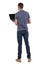 Back view of a man who is standing with a laptop