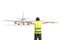 Back view of an marshaller signalling with wands in front of an aircraft