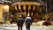 Back view of metallurgists walking inside the hot shop of the metallurgical production plant. Stock footage. Heavy