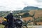 Back view of a motorbike traveler arrived at his destination and look at distance San Marino mountain on background, Adventure