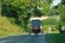 Back view of moving Amish horse and buggy