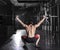 Back view of muscular athlete doing the crossfit exerise in the